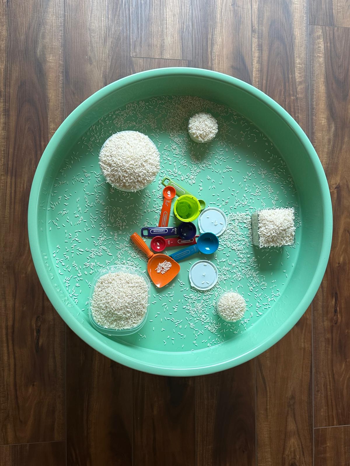 Rice scooping and pouring sensory tray